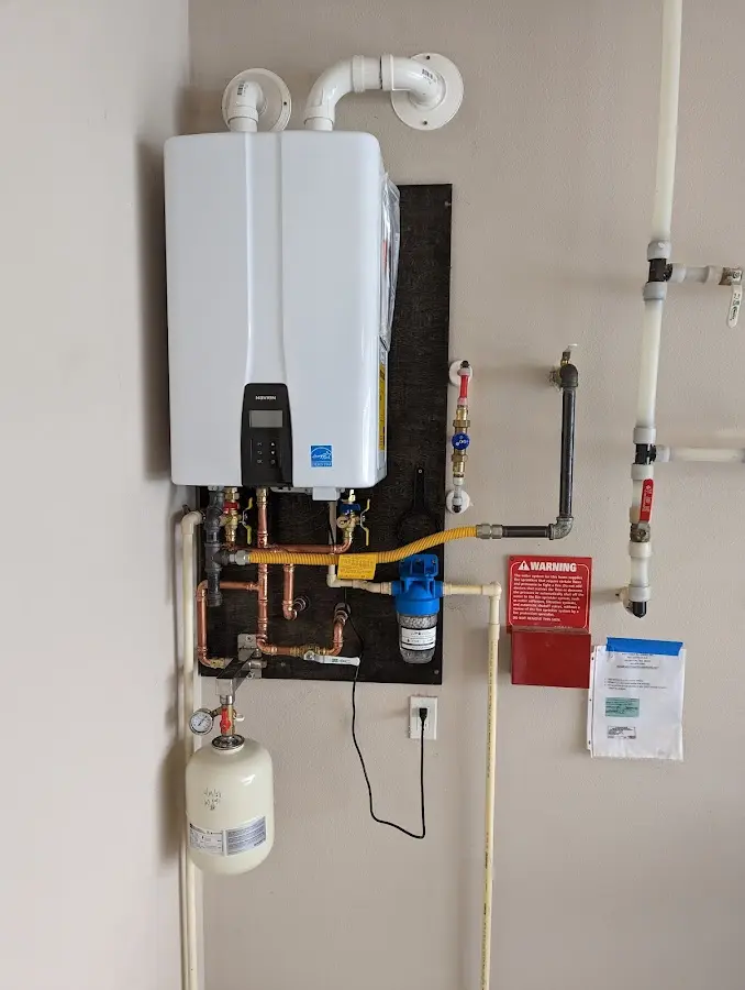 Professional plumber installing copper piping in a Baraga home